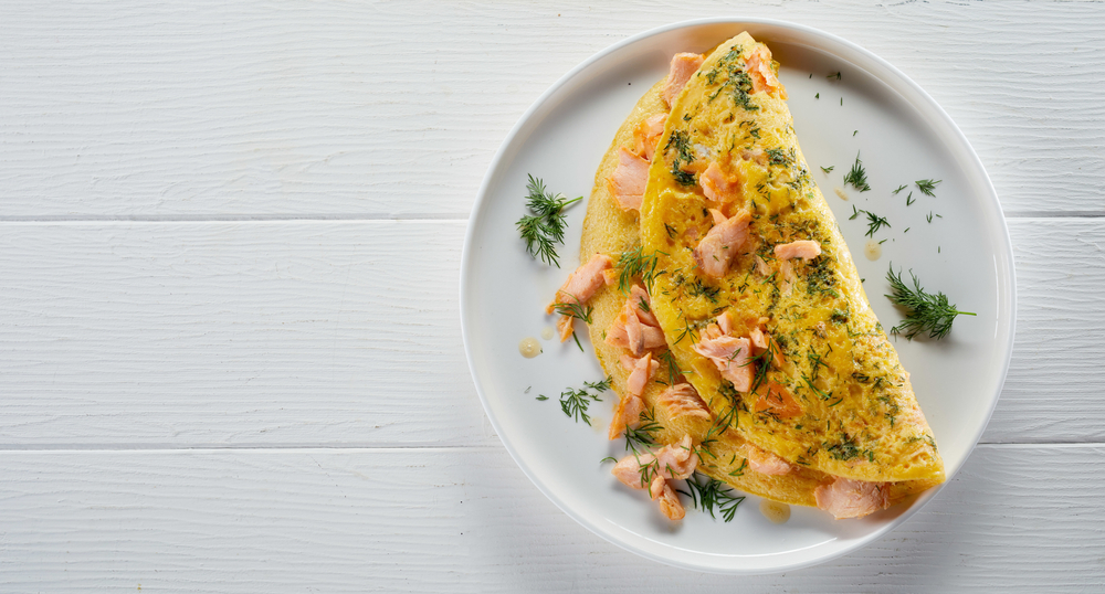 painted white wood with a white plate topped with a gorgeous seafood omelet!