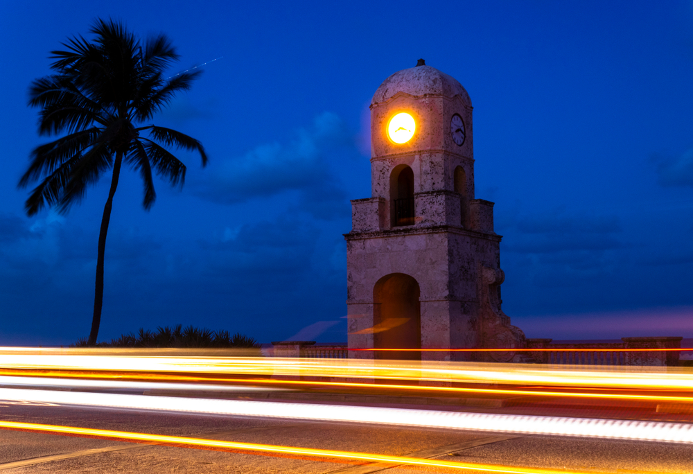 The Palm Beach clocktower at night with light trails streaking across the image.