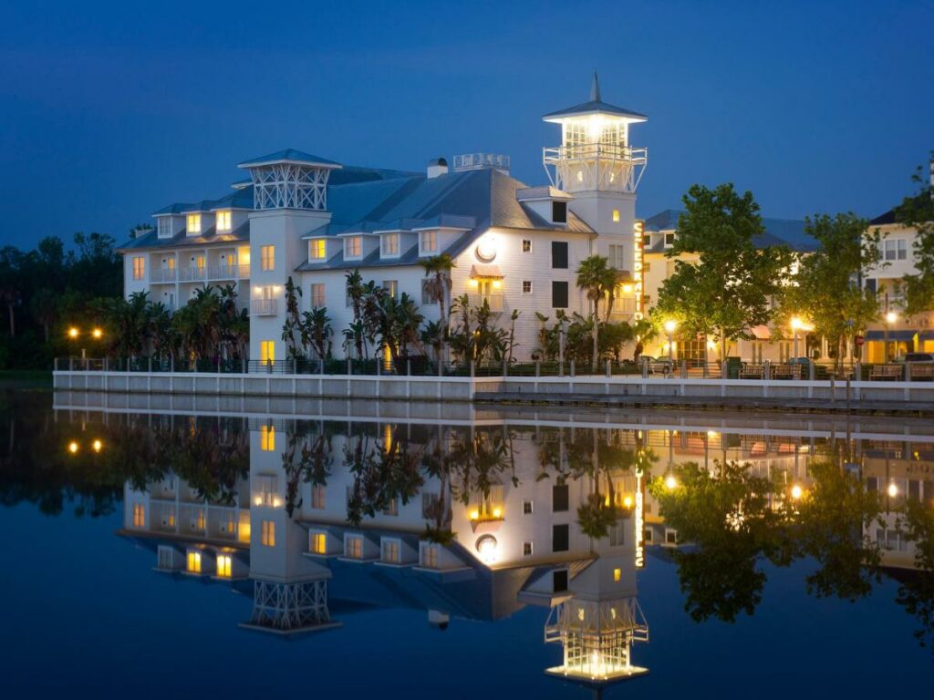 A picture of the bohemian Hotel Celebration at night, the reflection of the lights of the hotel create the illusion of it being underwater!  where to stay in Orlando for a lovely time 