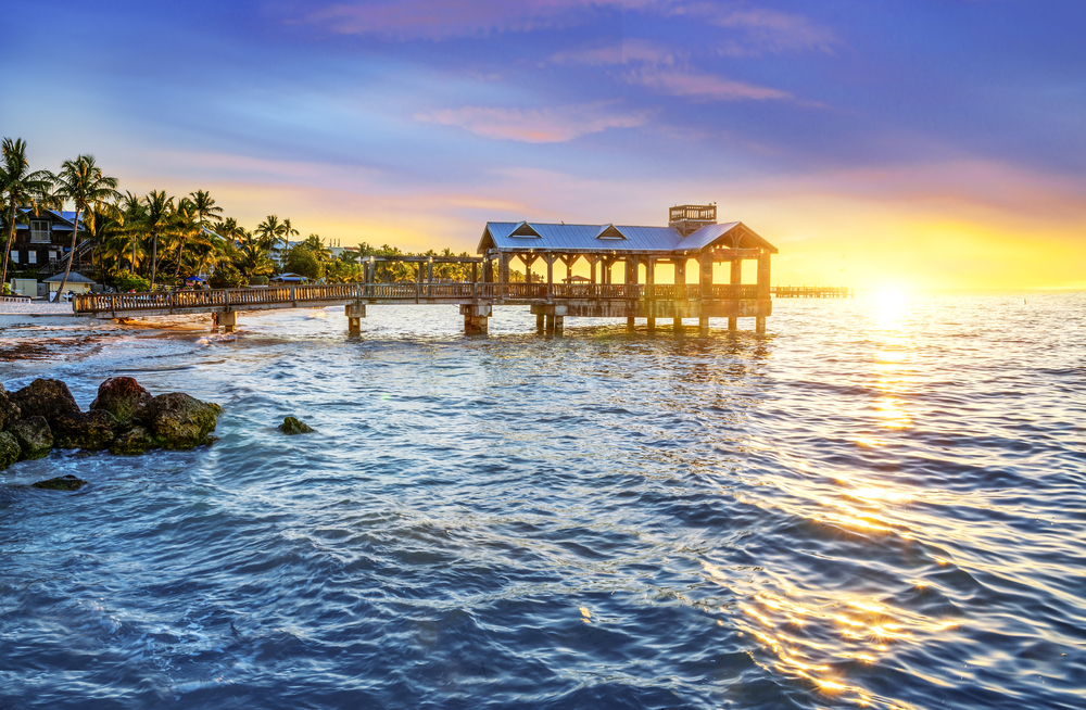 a picture of a covered pier on the beach at Key West at sunrise 