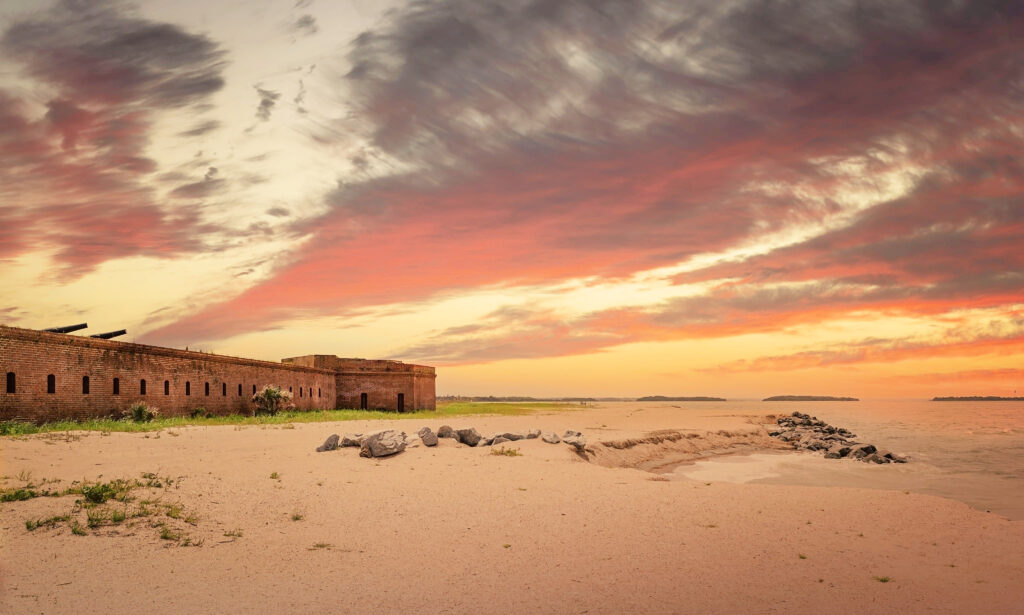 colorful sunset beside an orange brick Fort Clinch on East Coast beaches in North Florida