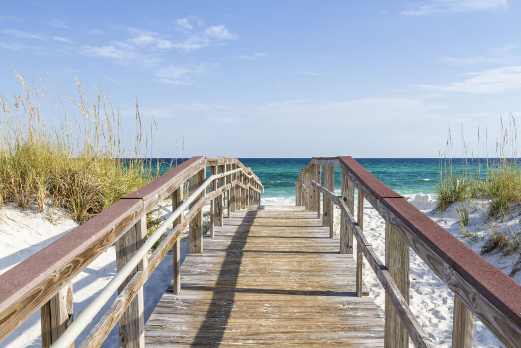 boardwalk leading to white sand beach