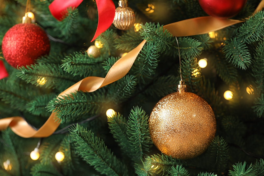 Close up of golden ornament on a Christmas tree.