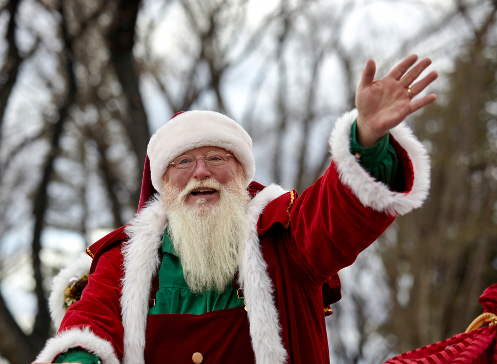 Santa Claus waving in a parade.