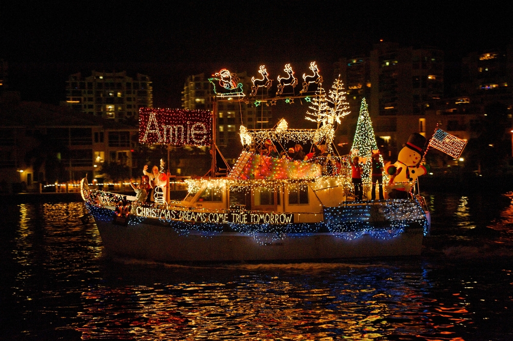 A decorated boat with Christmas lights at night.