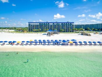 blue colored hotel on the beach with umbrella and sunbeds best beachfront hotels in destin