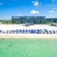 blue colored hotel on the beach with umbrella and sunbeds best beachfront hotels in destin