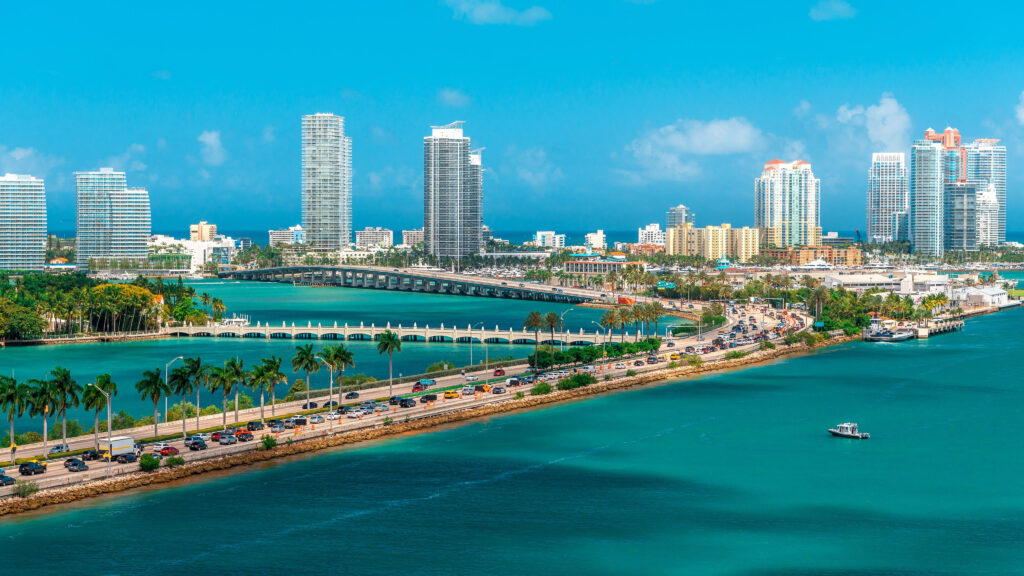 Miami’s waterways and bridges with spare sky rises along the horizon depicting warmest city in Florida in January