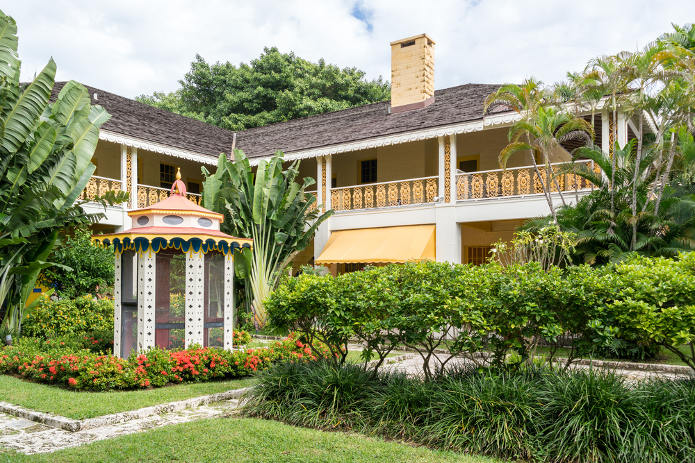 Detailed yellow and white exterior, with a small gazebo in the foreground at the Bonnet House, one of the best things to do in Fort Lauderdale, FL.