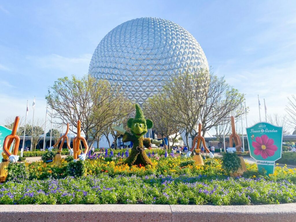 d. The Epcot International Flower and Garden Festival showing a display with Mickey and the Globe behind