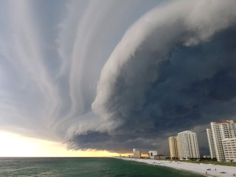 Rain clouds gathering above a beach showing the beach and buildings 