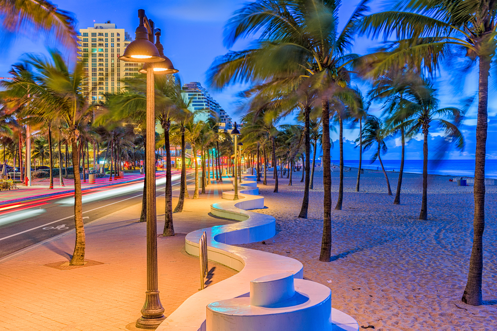 A beach in Florida in June as the sun is setting just on the side of a road in a major city