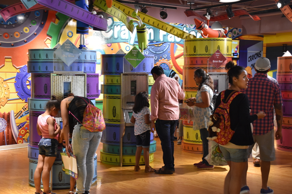 A bunch of families gather around the exhibitions of the Crayola experience in Orlando. The interactive nature of these tours makes Orlando with kids fun! 