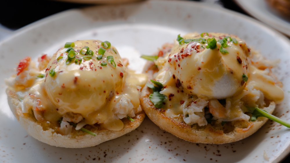 Poached eggs sit on top of crab meat on English muffins, much like the crab Benedict served during brunch at Sails Restaurant in Naples.