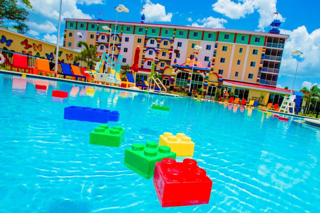 swimming pool at a hotel with large lego brikes in teh water. The article is about  the best hotels near Legoland, Florida.