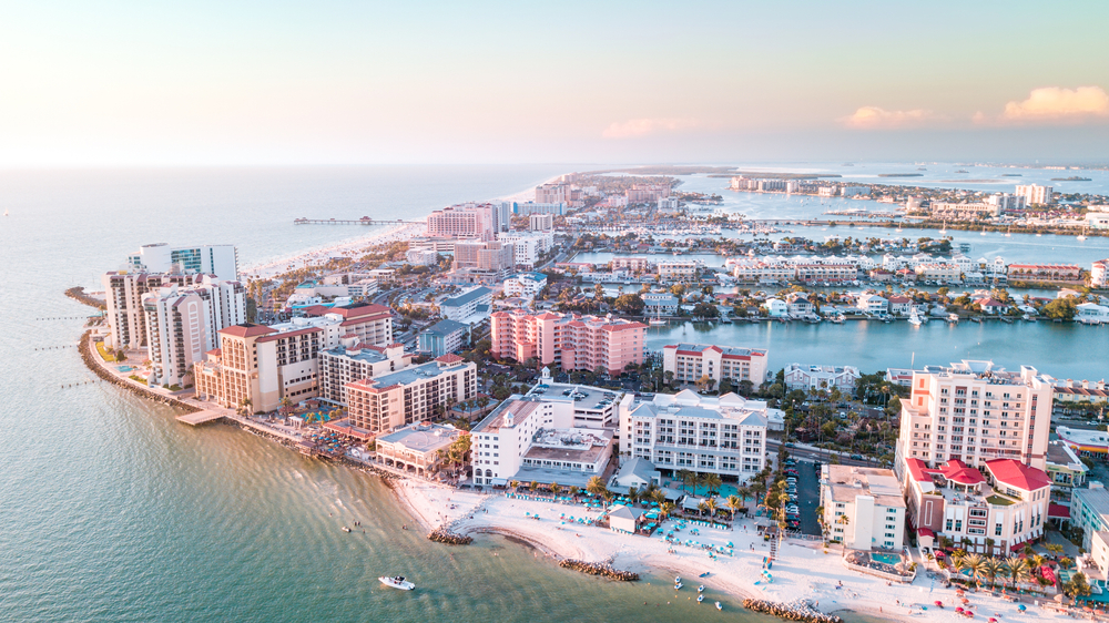 An aerial view of Clearwater Beach, FL. The sun is rising and everything has a pastel look to it