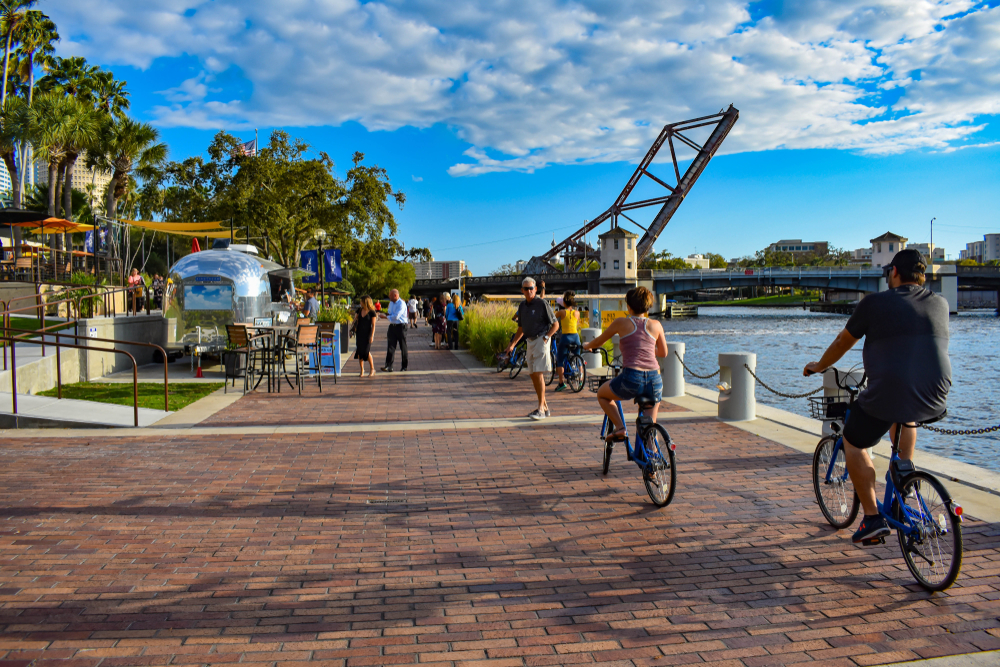 People biking and walking at Riverwalk in downtown area