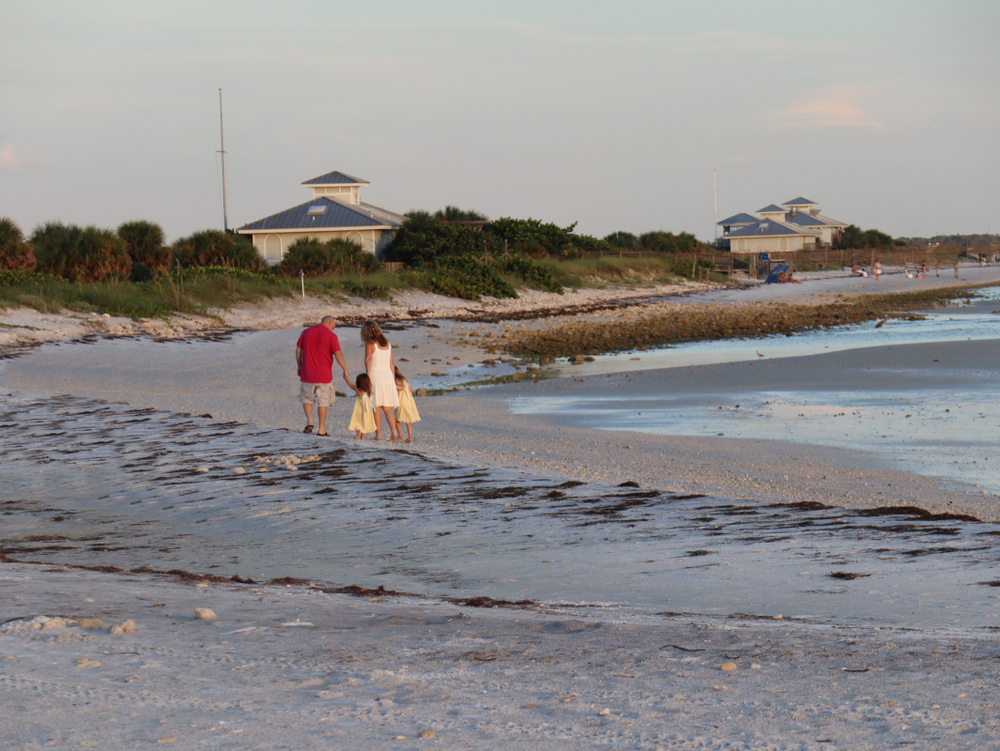 A family walking on Honeymoon Island Beach in Dunedin Florida