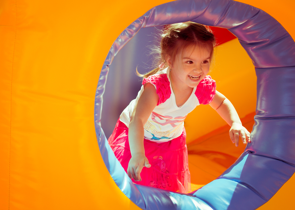 child on a colorful trampoline having fun.