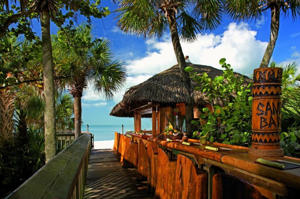 Boardwalk past a Tiki hut to the beach.