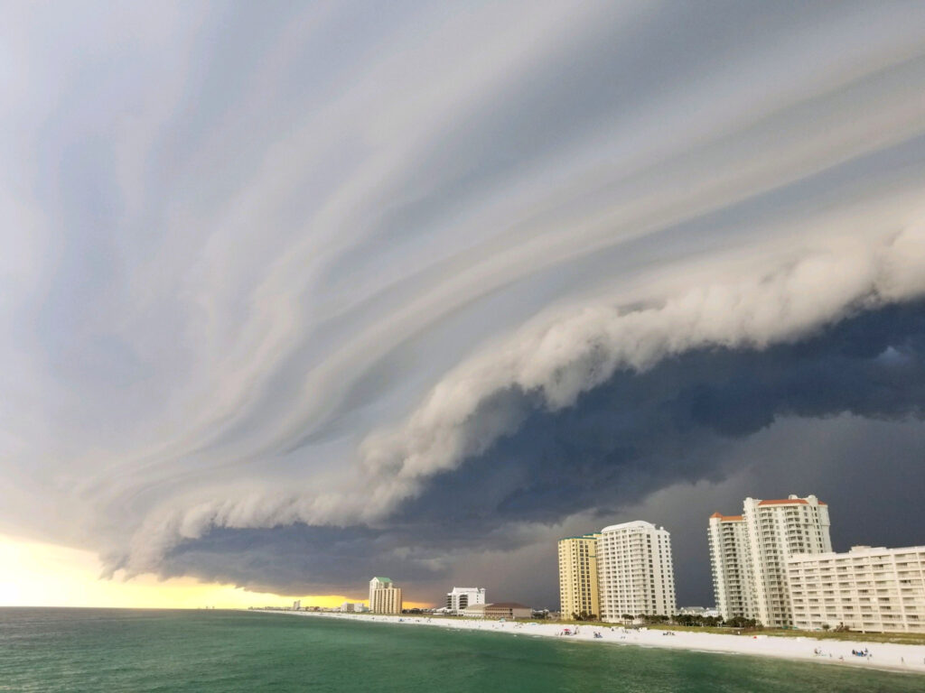 Large cloud with tumuluous weather towering above Florida beaches and condos