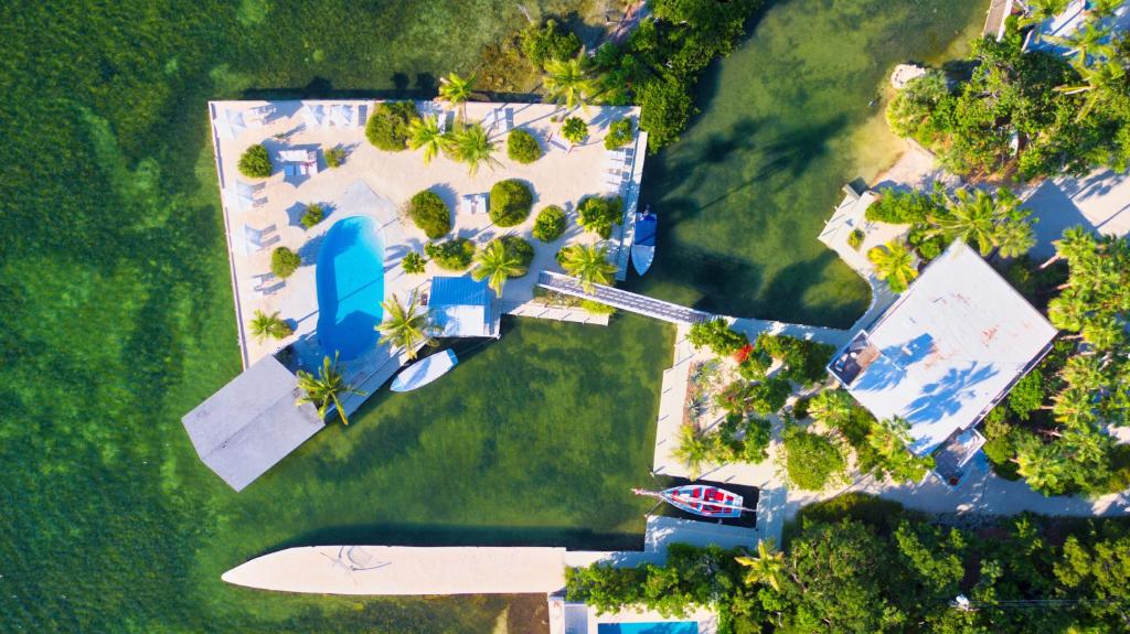 an ariel view of casa morada resort with the private boat, pool, bungalows, surrounded by the ocean
