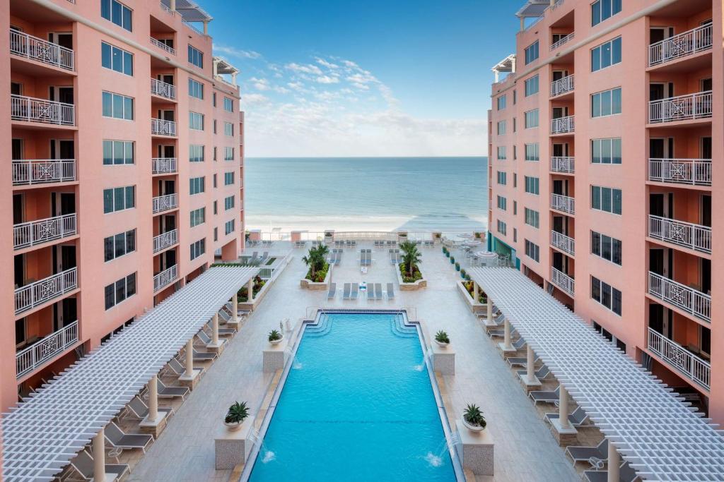 beachfront resort in clearwater beach with blue pool and pink buildings looking over the ocean