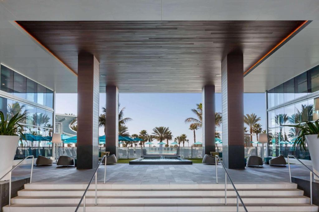 View from hotel onto a huge open lobby with palm trees beyond.  