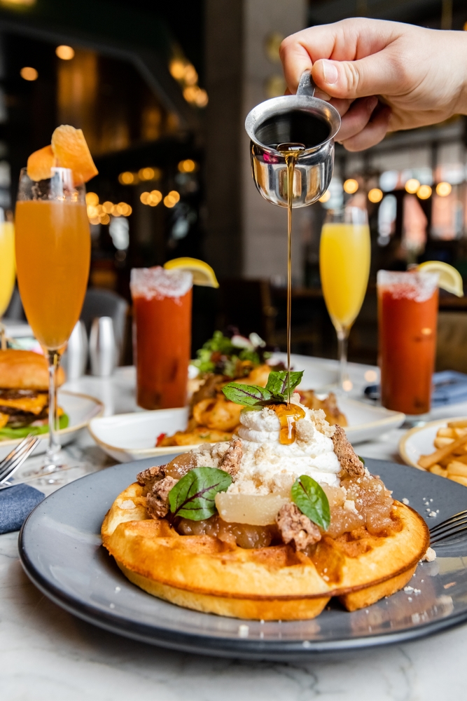mimosas make the best brunch in orlando sered with waffle topped with fruit and 