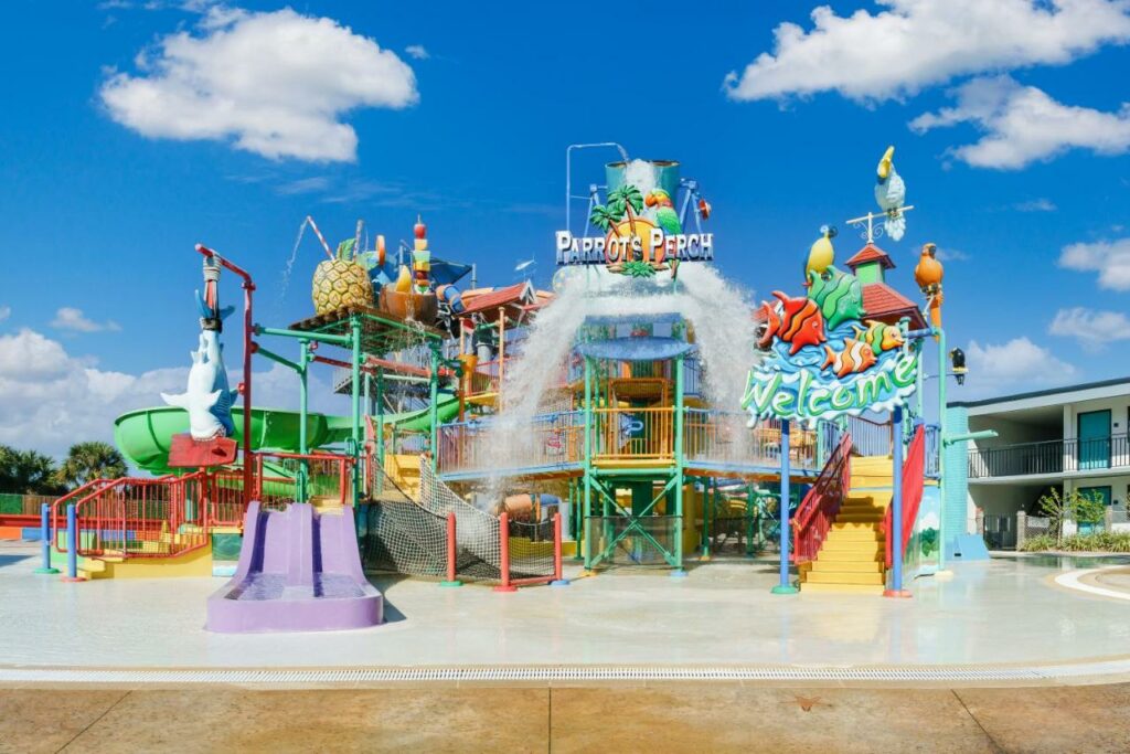 The Parrots Perch splash pad features slides and lots of water dumping buckets at one of the  best waterpark hotels in Orlando: Coco Key.