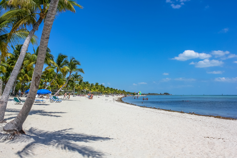 The curve of the ocean along Smathers Beach shows the length of this private beach that is prefect to visit in Florida in December. 