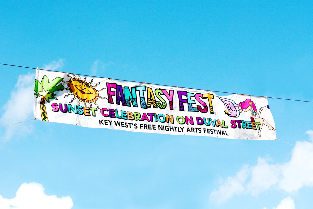 In Florida in October Fantasy Fest in Key West is a popular destination: in this photo, the banner for the arts festival is bright with lots of colors as it flaps in a blue sky. 