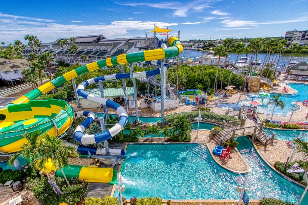 An aerial view at a large waterpark with pools, colorful waterslides, and a lazy river at one of the best hotels for where to stay in Tampa FL