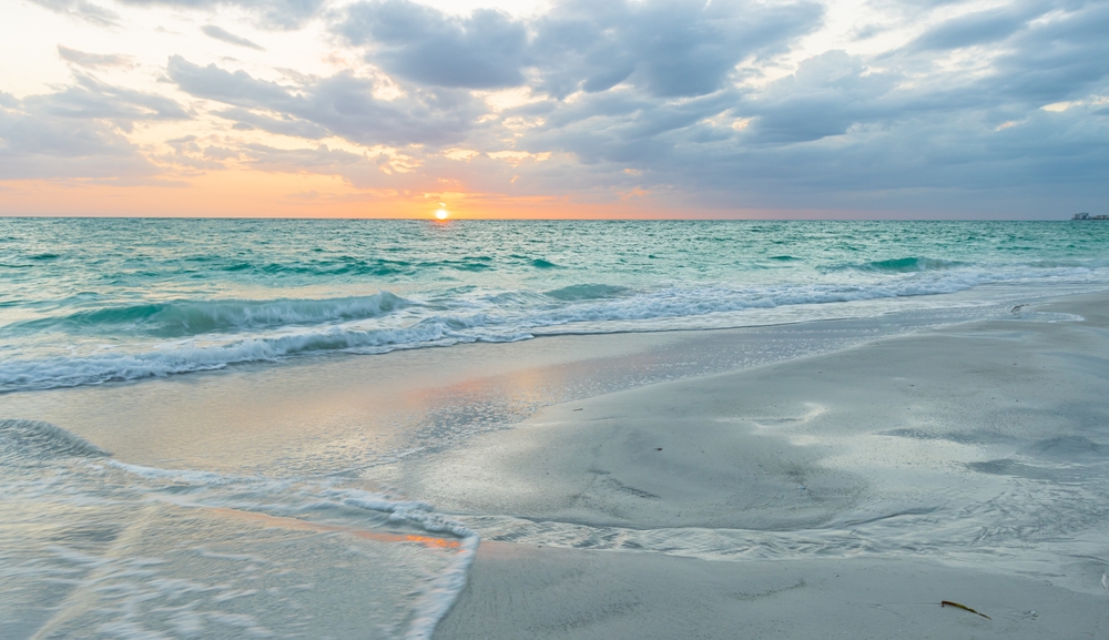 the lido beach at sunrise with candy colored sky and turquoise water