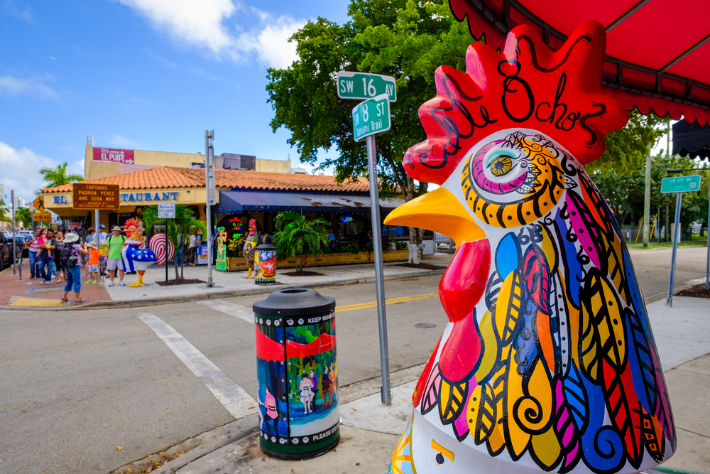 A giant painted chicken sculpture stands on the street corner in Little Havana, where doing a food tour is one of the best things to do in Miami for adults.
