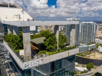 rooftop bar in miami covered with greenery and cement building