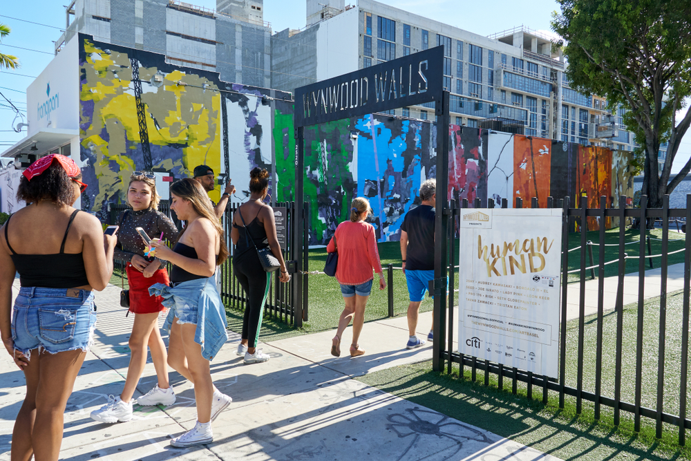 Half a dozen people walk in and out of the Wynwood Walls entrance gate, where looking at the murals are one of the best things to do in Miami for adults.
