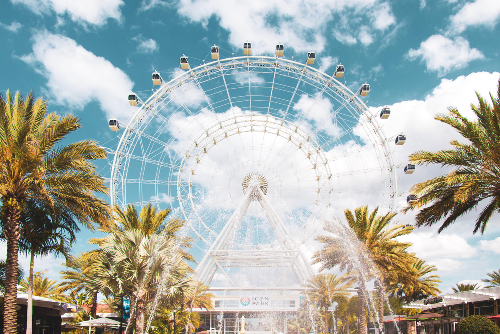 The wheel at Icon Park with palm trees and a fountain in front of it. It's a great thing to do in a weekend in Orlando.