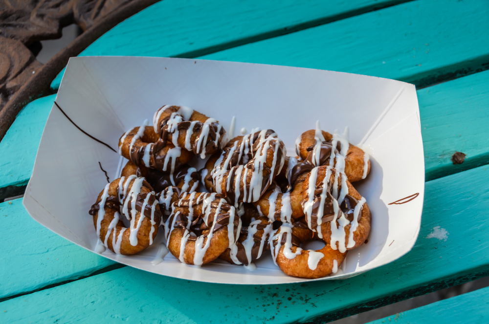 A collection of mini donuts featured at one of the best restaurant in Siesta Key features toppings like icing and Oreo crumbles. 