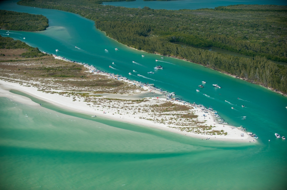 Keewaydin Island aerial view north of Marco Island Florida .  You can see lots of boats on the water. 