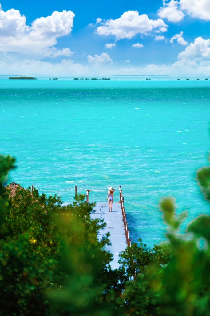 View looking down at a woman on a dock overlooking the ocean on a Florida road trip.