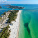 aerial view of a beach with white sandy and green-blue water beaches in anna maria island