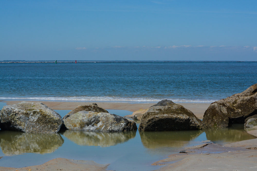 a beautiful beach at Fort Clinch State Park with rocks and small tidal waves on the shore. 