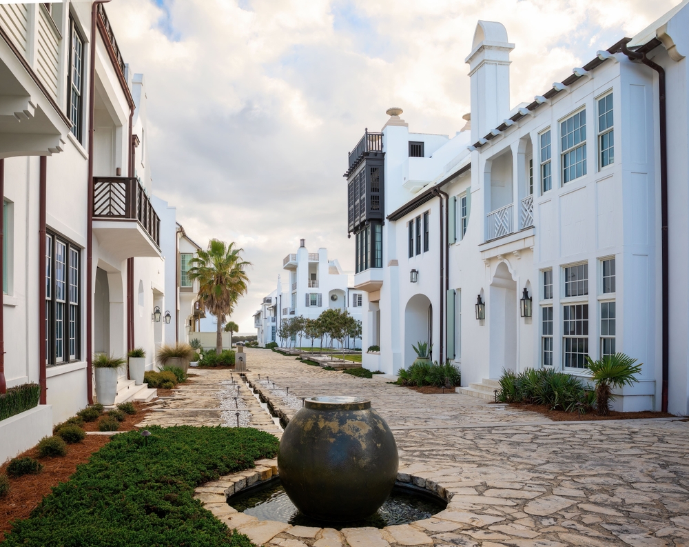 the Alys beach in florida with cobbled streets and white washed buildings looks like just a greek down. you can see the beach in the distance and plenty of pretty palm trees this is one of the places in florida that look like Europe 