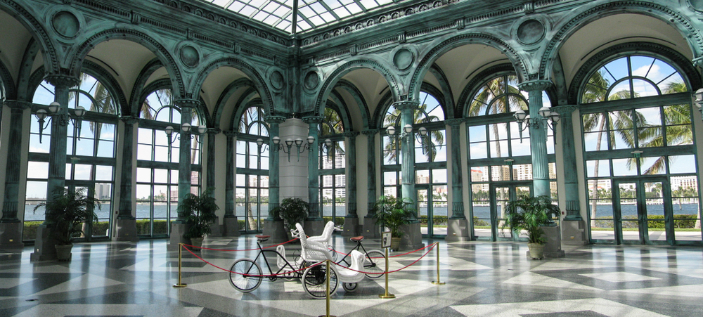 a big museum in florida that looks like Europe with a tiled floor and big windows. there is a cart in the middle that is the main display of this room 