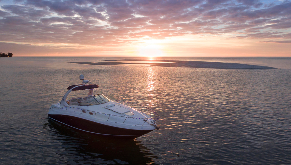 Luxury Boat Anchored by Sandbar in Sarasota Florida during sunset
