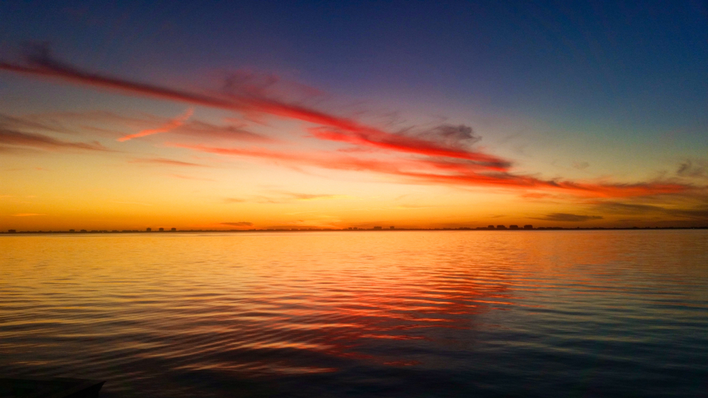 sunset from the water red and orange colors. The bets sunset in Sarasota/ 
