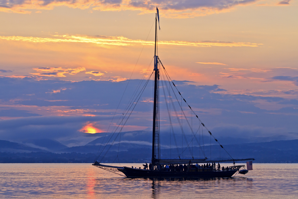 A sunset cruise line offers tours to see the sunsets in Florida up close and personal: this orange sun hides behind clouds as it sets. 