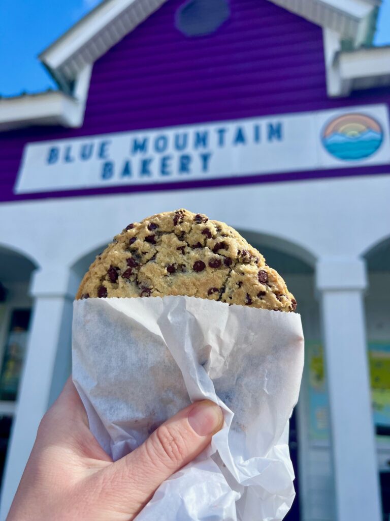 a cookie in front of Blue Mountain Bakery in 30A