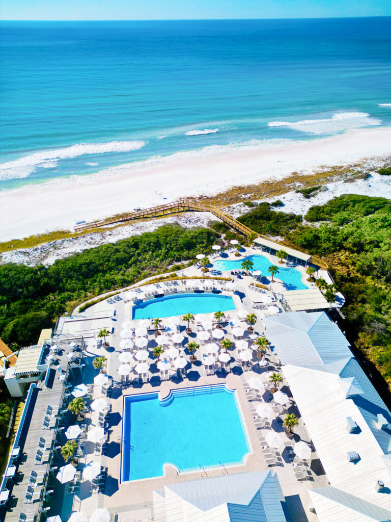 an Ariel view of the pool overlooking the ocean in Watercolor one of the towns on our 30A travel Guide